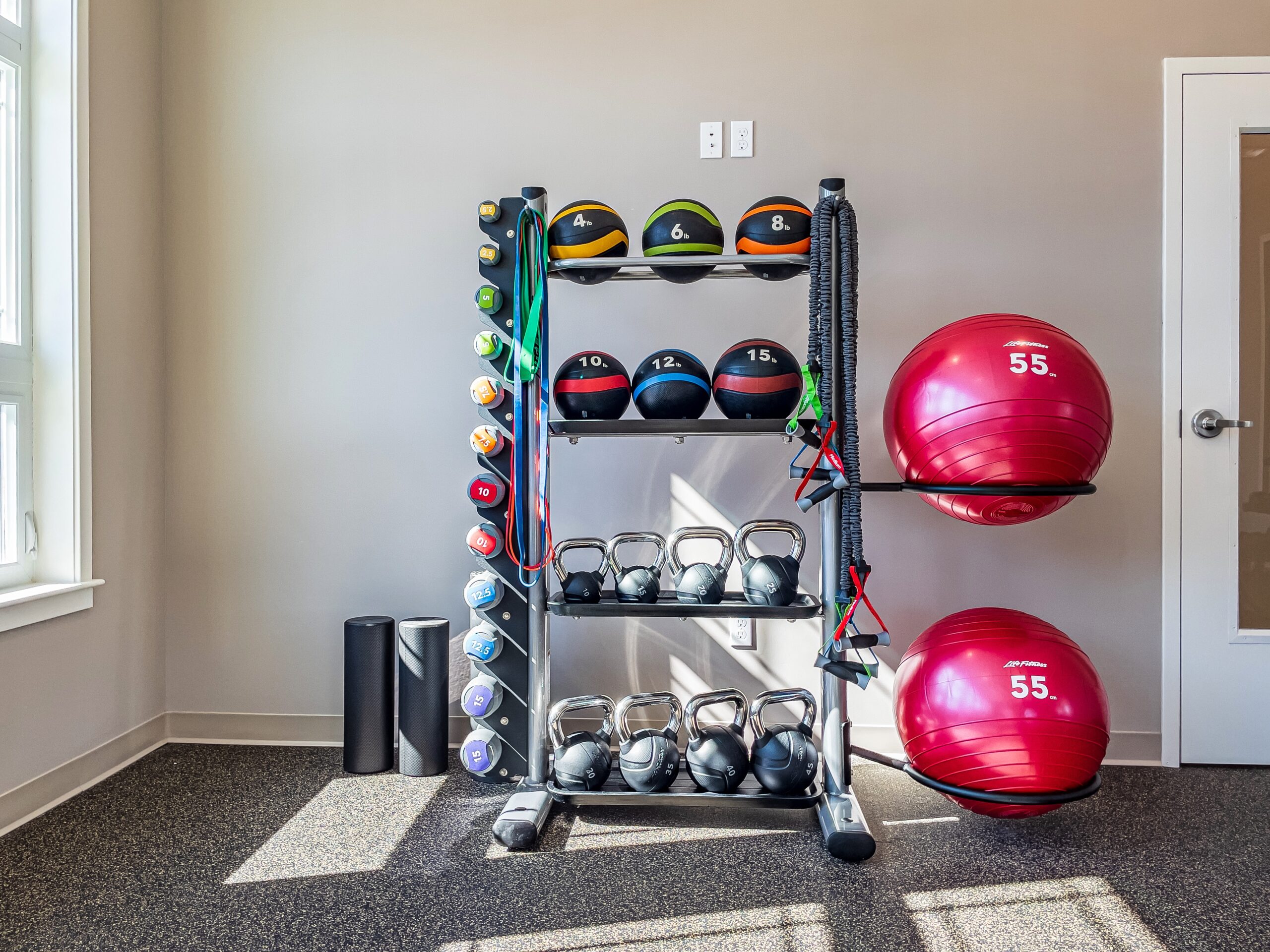 exercise room with kettlebells, physio balls, bands and slam balls. 